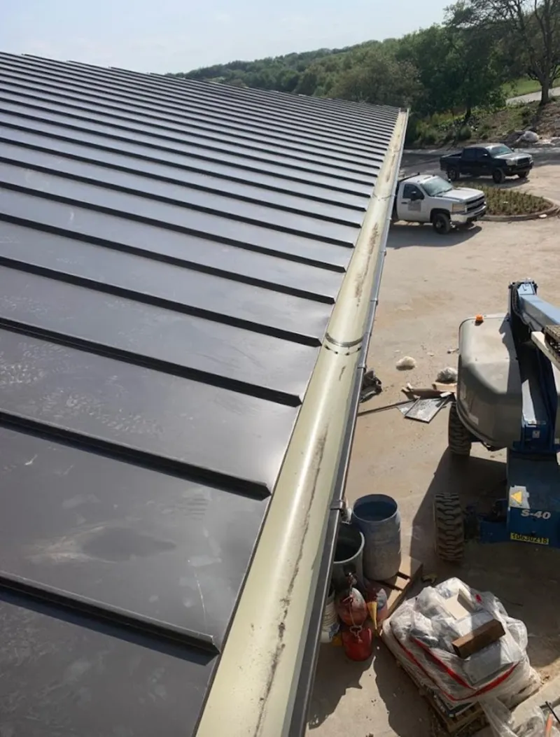 Standing seam panel and gutter detail on a metal roofing jobsite in Melbourne